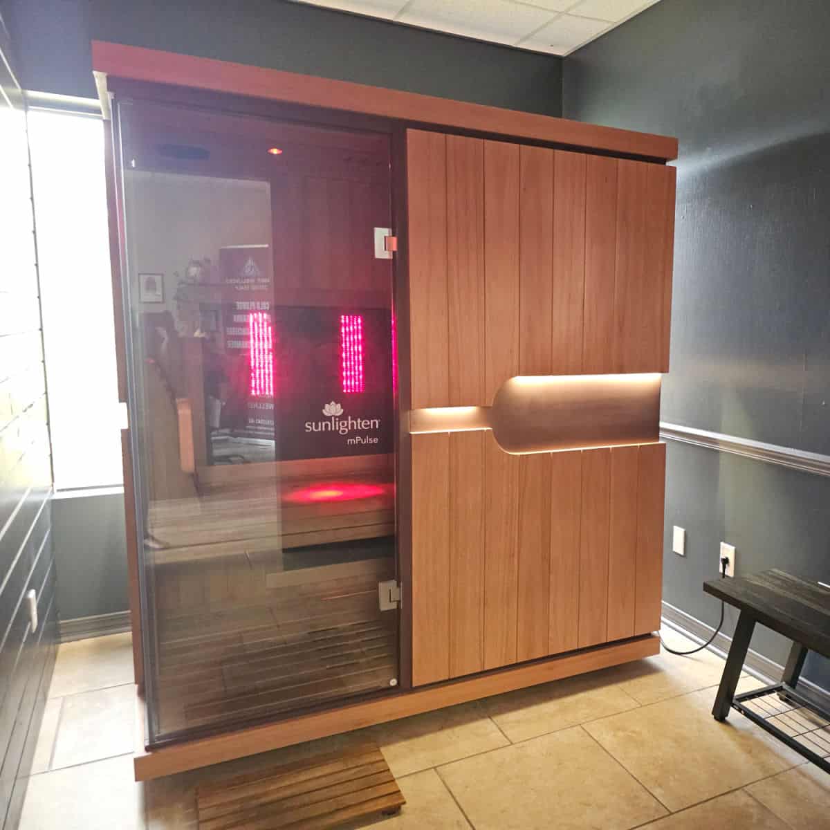 Infrared sauna in a room with a bench next to it