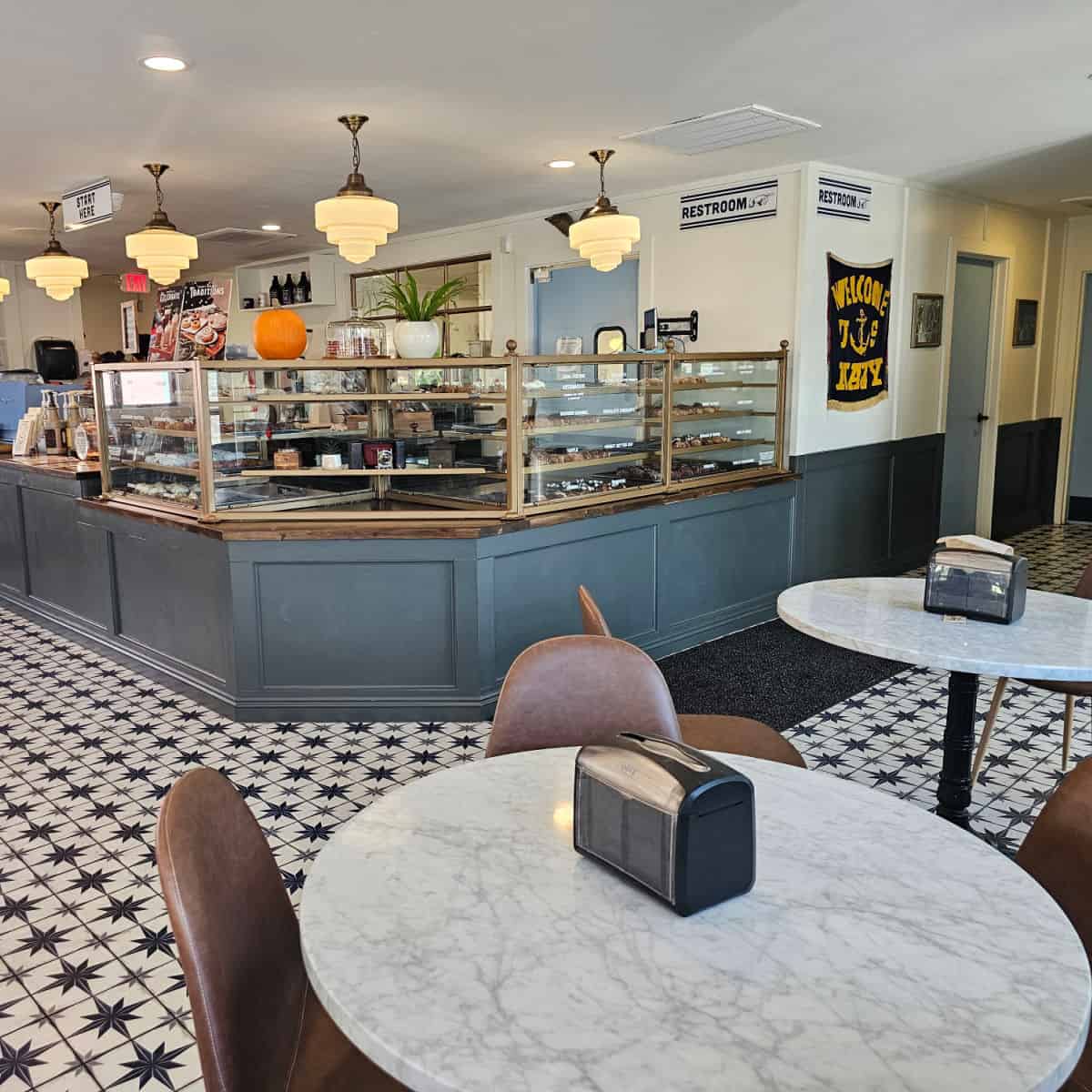 parlor doughnuts indoor eating with white table, leather chair, and cabinet with donuts