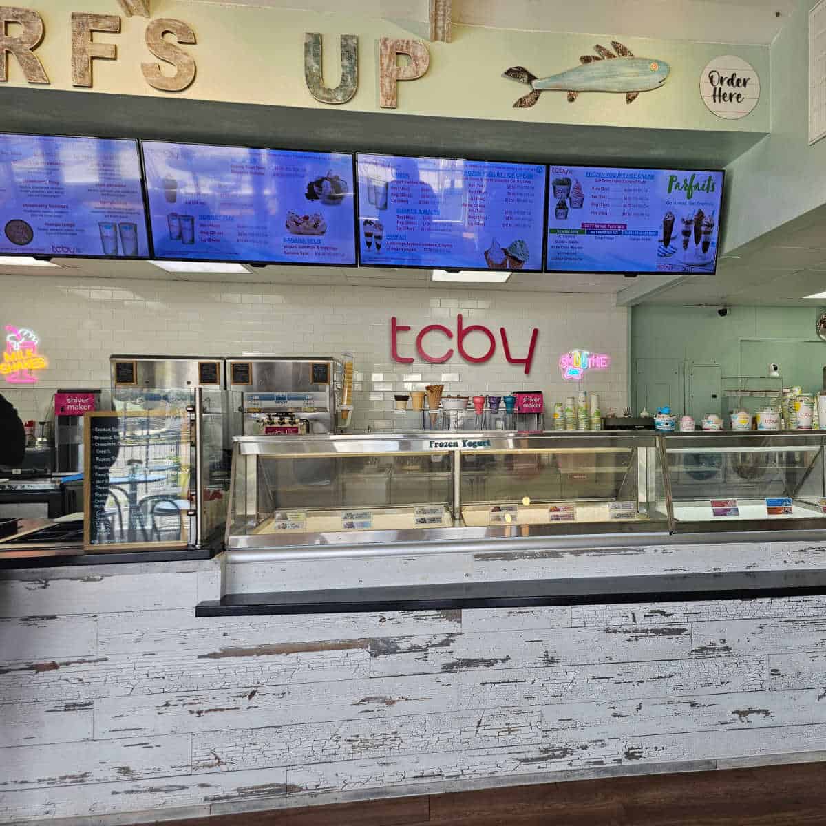Inside TCBY with a menu over the counter, ice cream area