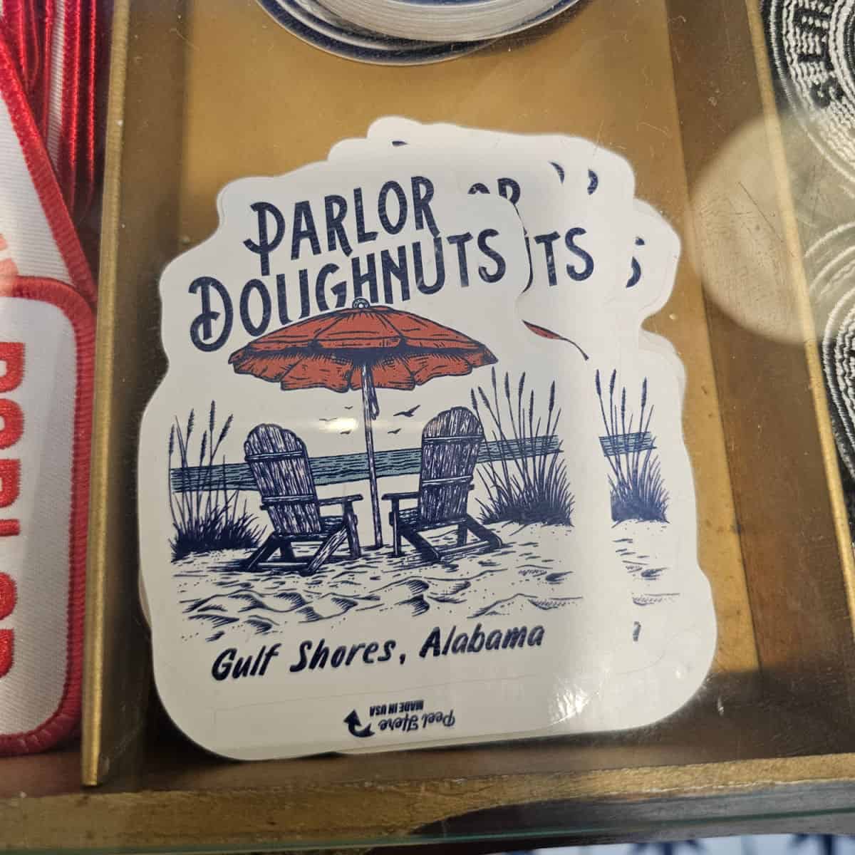 Parlor Doughnuts gulf shores alabama sticker with beach chairs and an umbrella
