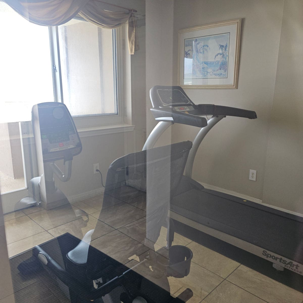 fitness center with an exercise bike and treadmill