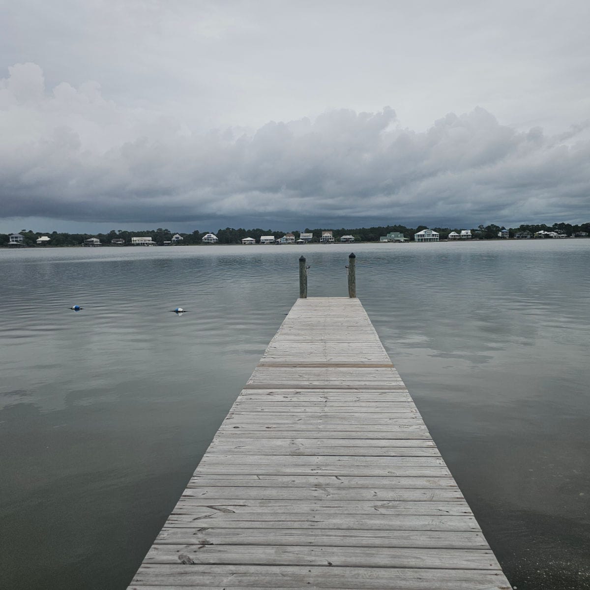 looking down a pier on a cloudy day on Little Lagoon