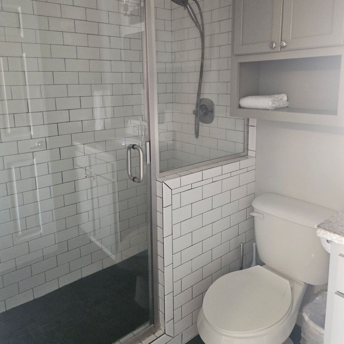 subway tile lined walk in shower