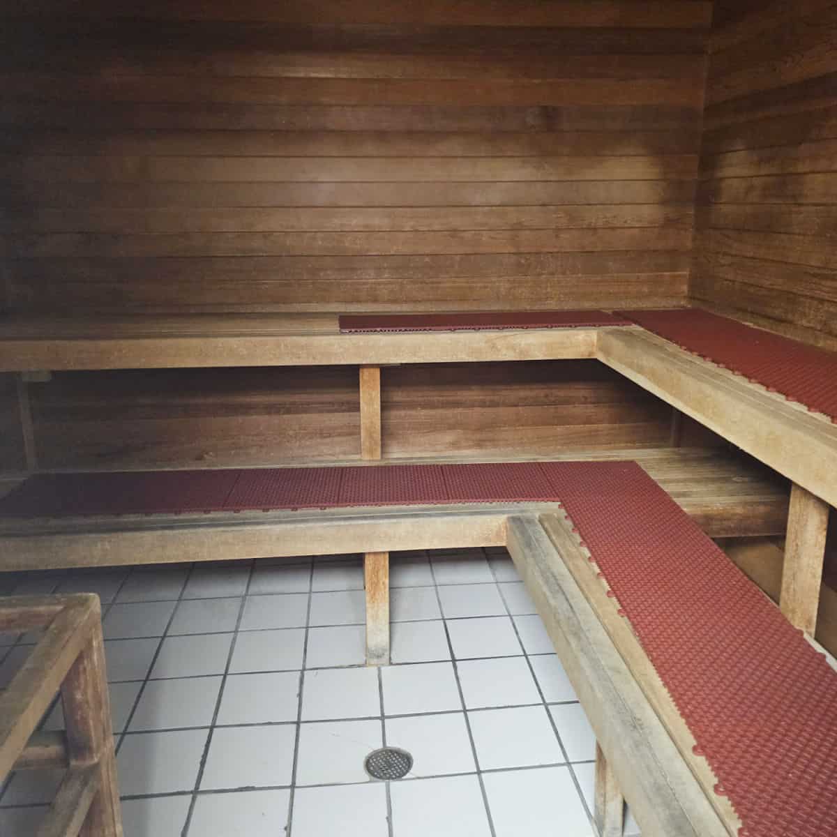 sauna with red mats on the wooden bench