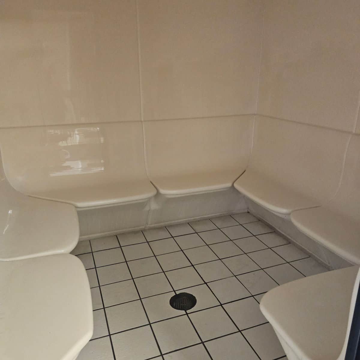 steam room with plastic white seats