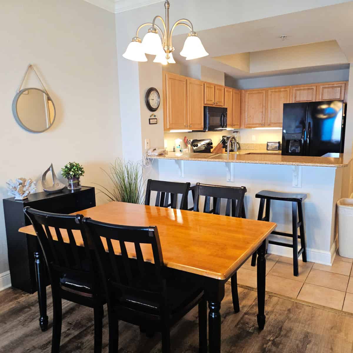 kitchen and living room with a wooden table, dark chairs