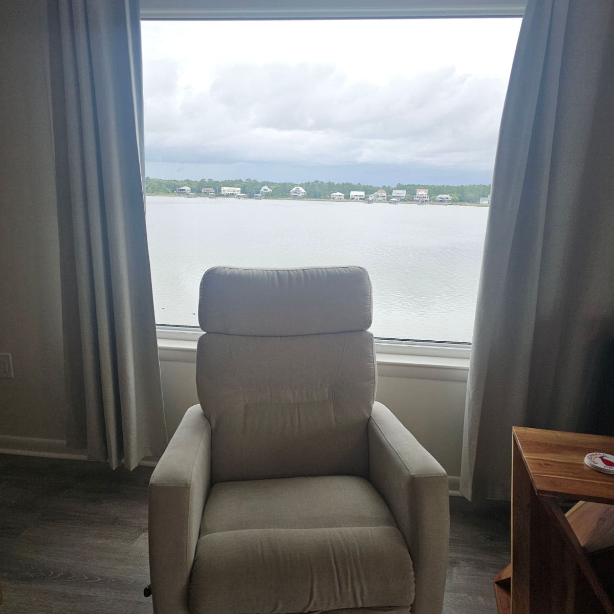 recliner chair in front of a window with Little Lagoon seen in the window