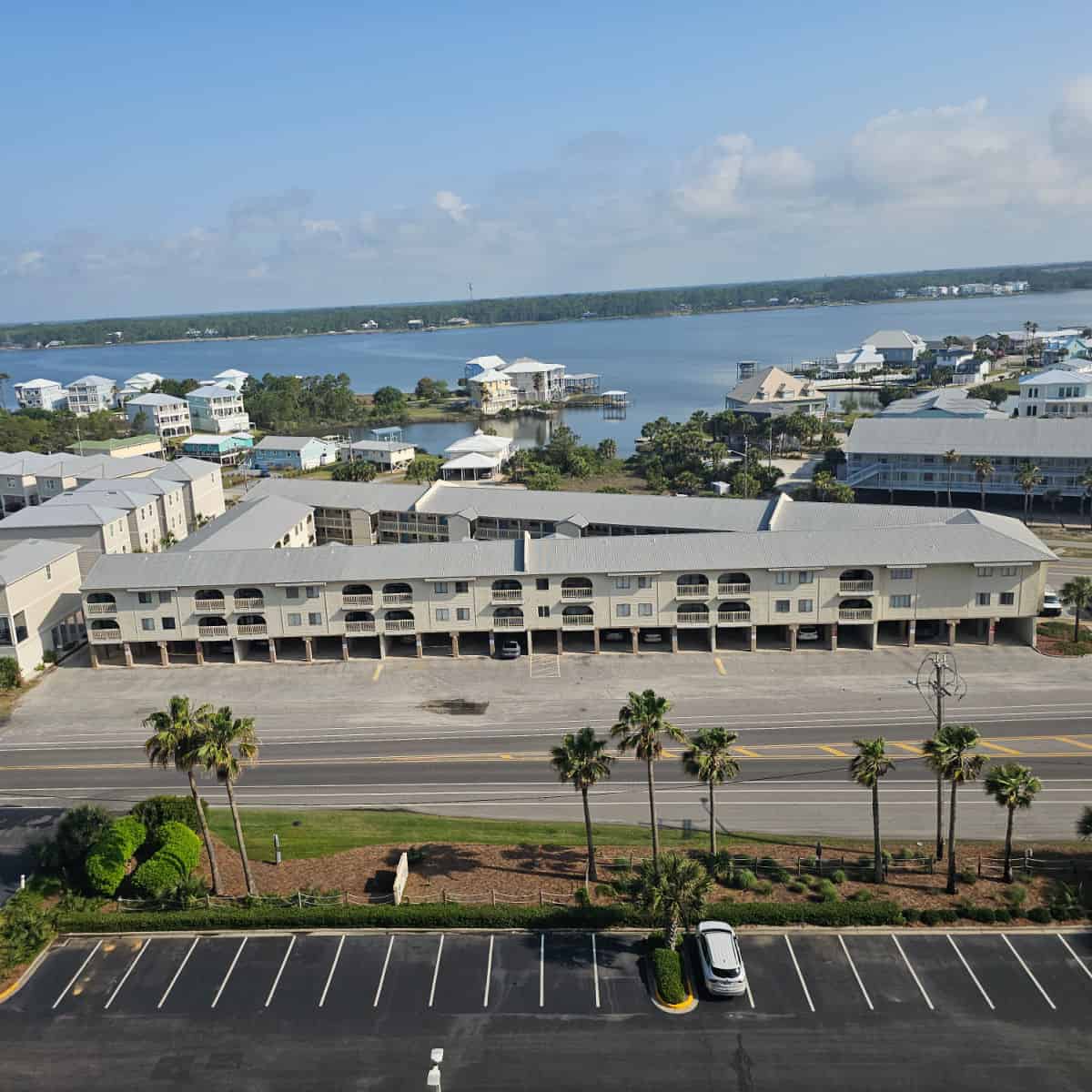 Triangle shaped building seen from overhead with Little Lagoon and other houses and buildings in the background