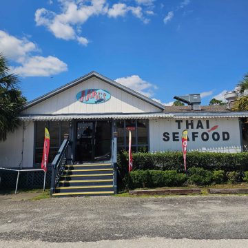 Niki's Thai Seafood building exterior with open signs and steps leading up to the front door