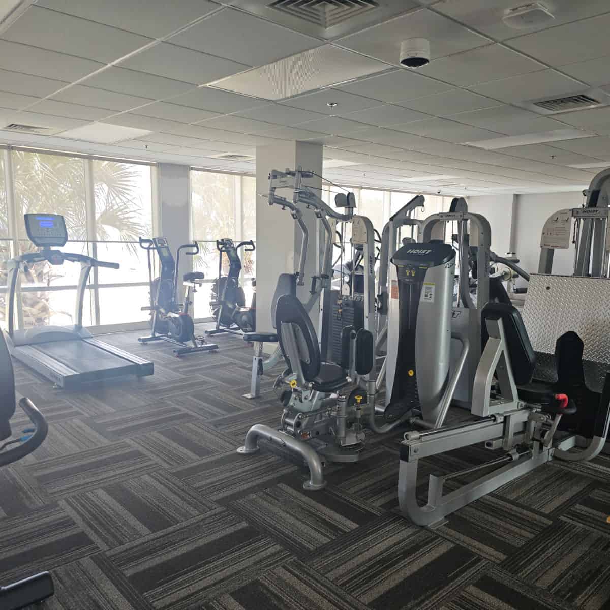 fitness center with treadmill and weight machines.