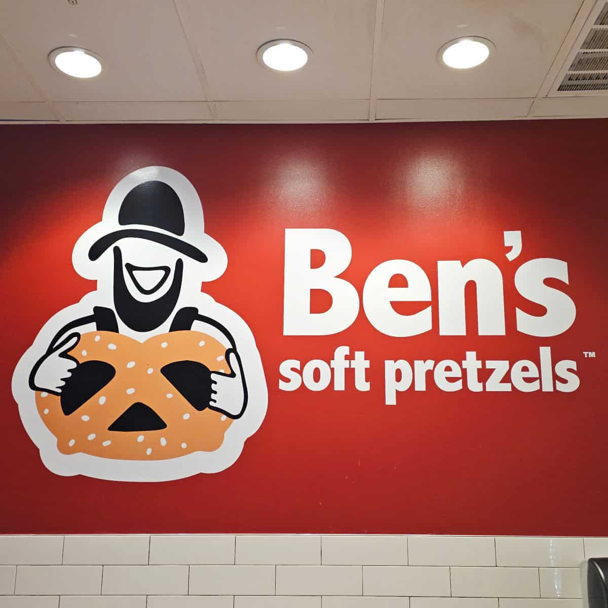 Ben's Soft Pretzels logo on a red wall