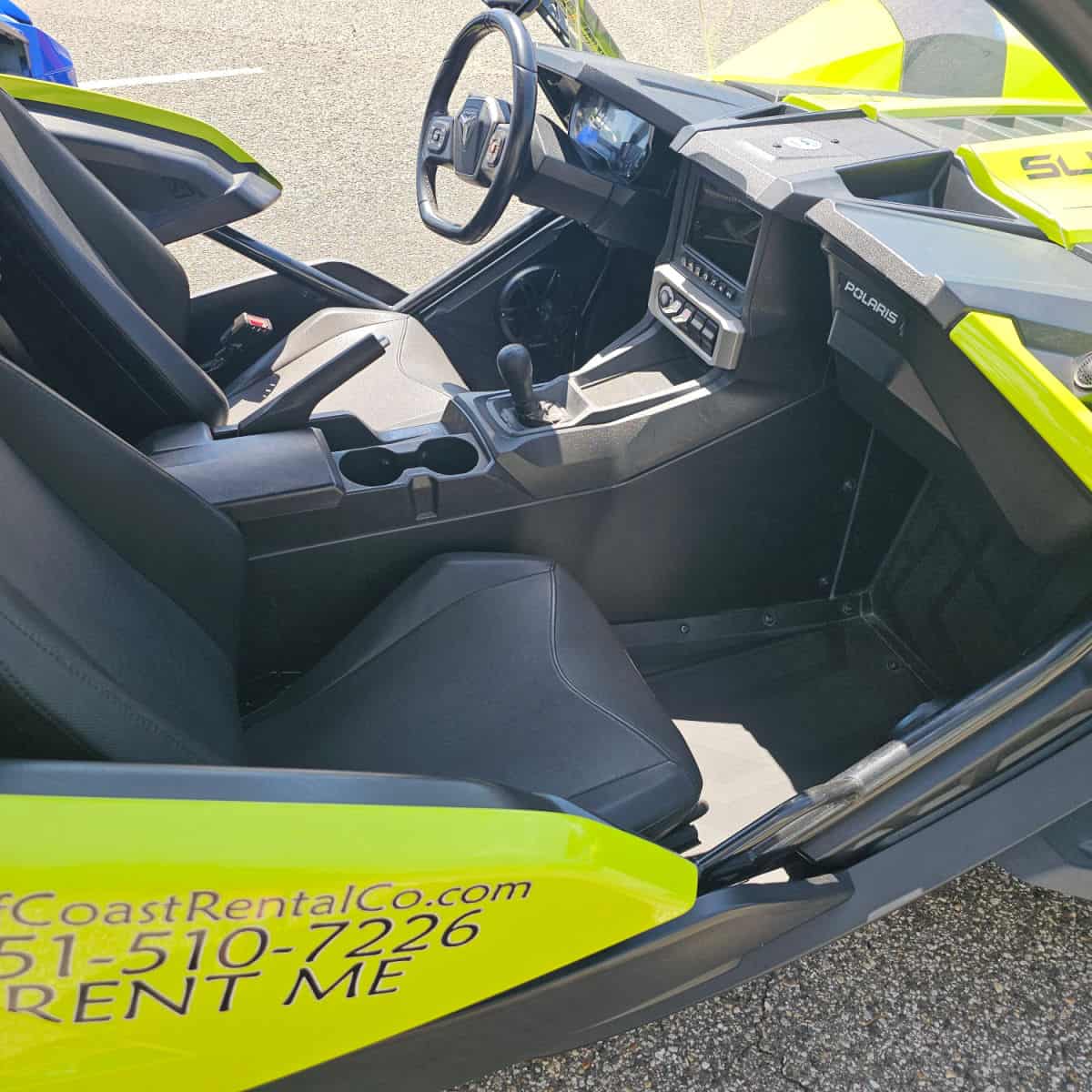 Looking down into a green Polaris slingshot that is open