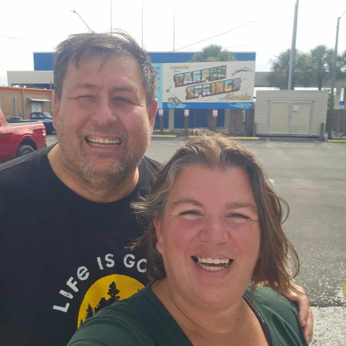 Tammilee and John in front of a Tarpon Springs Florida sign