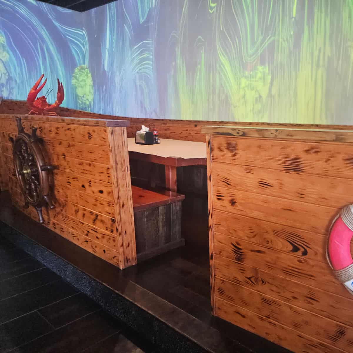 table area shaped like a large boat with a lobster on the end