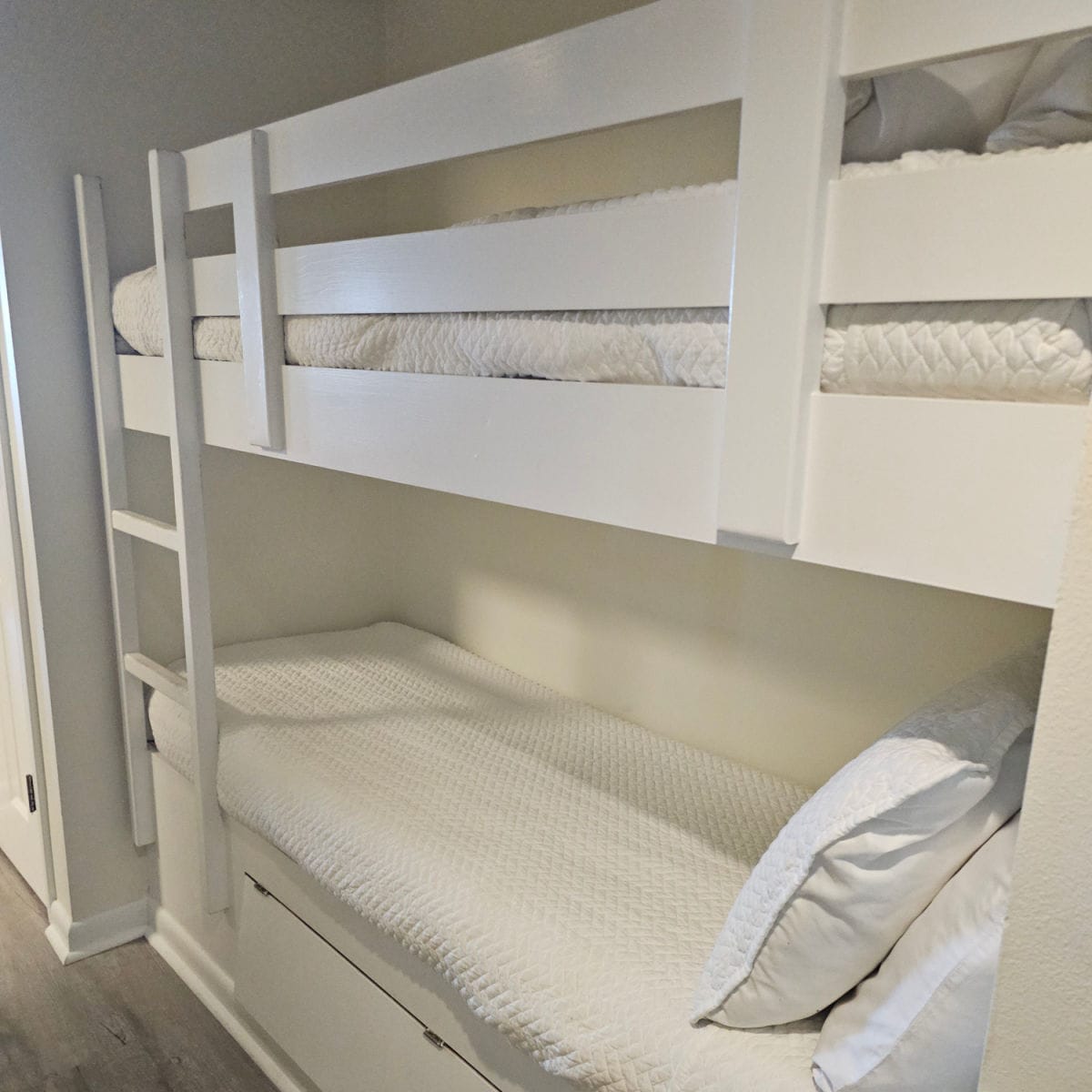 white bunkbeds with white linens
