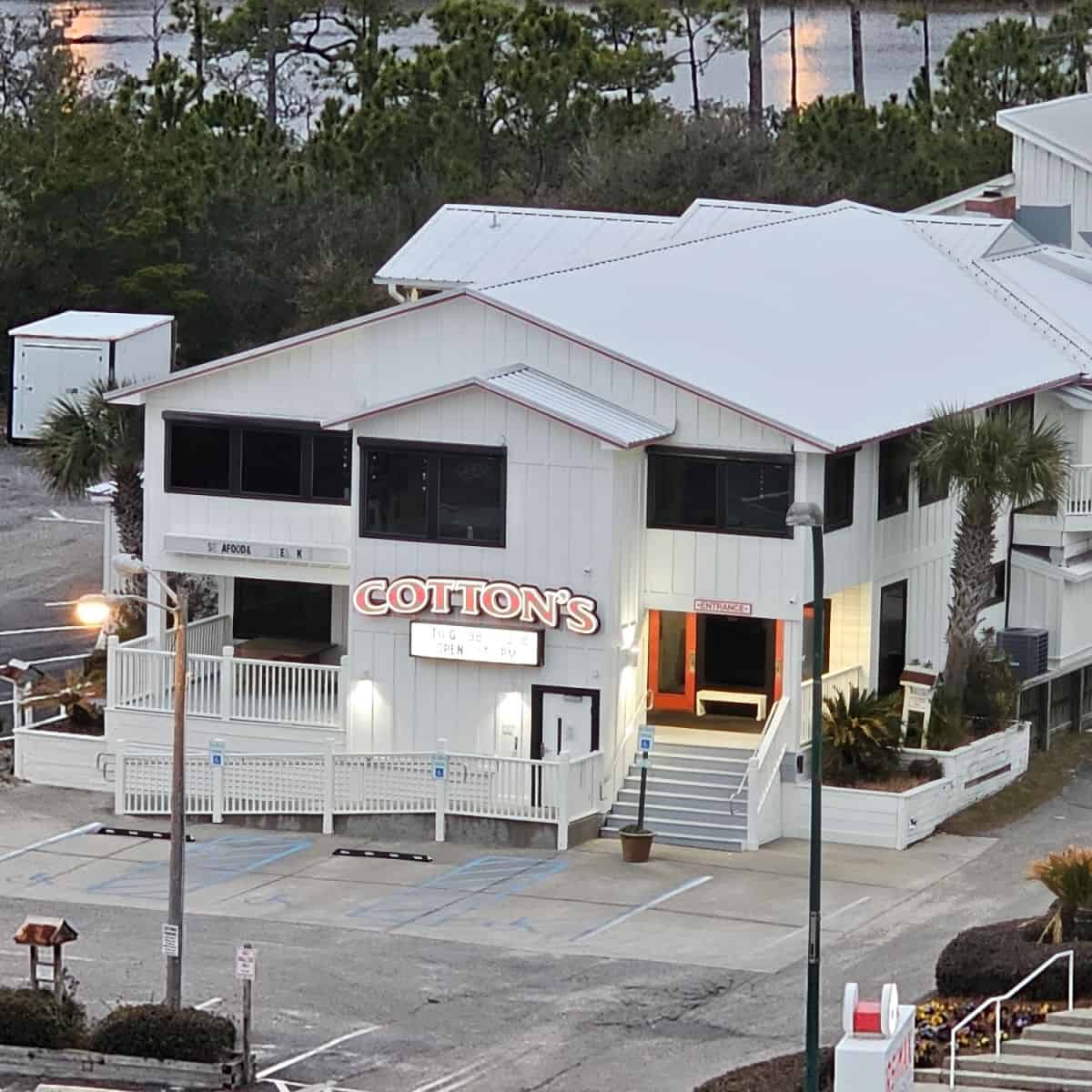looking down over a white building with Cotton's red sign