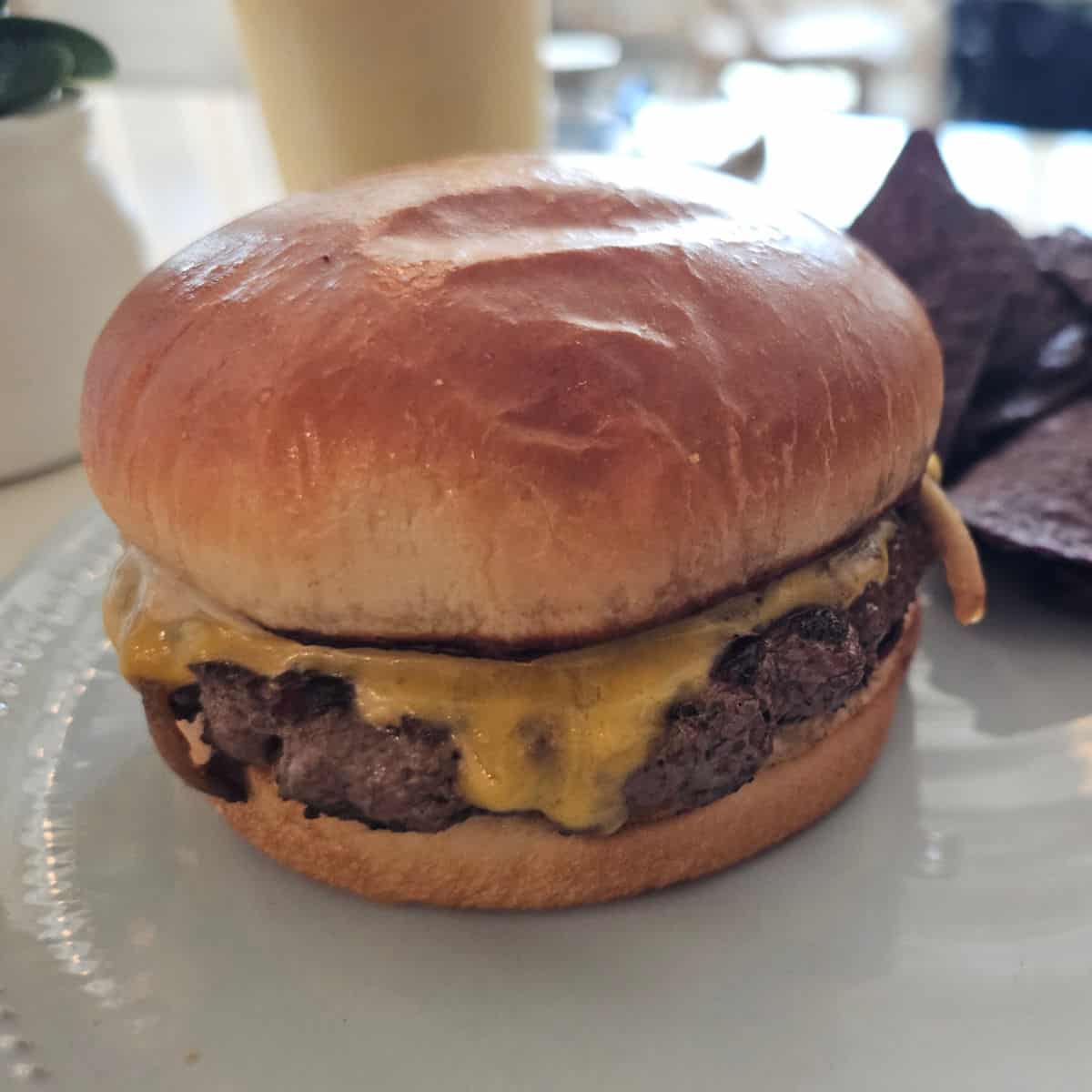 burger with cheese on a white plate