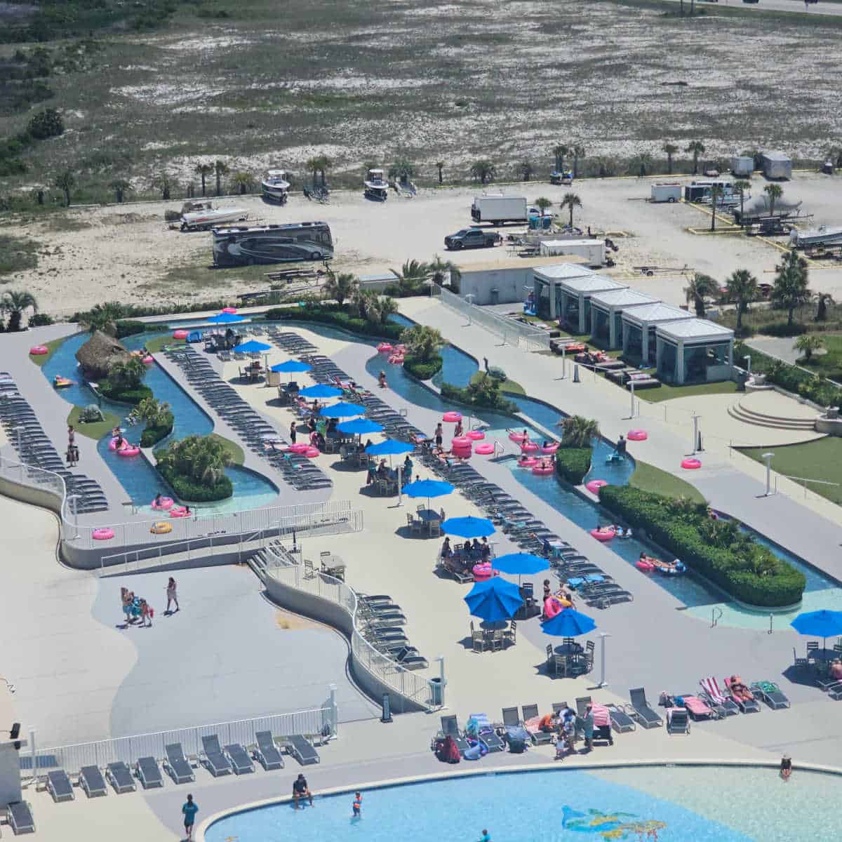 looking down over a large lazy river with pink intertubes in it