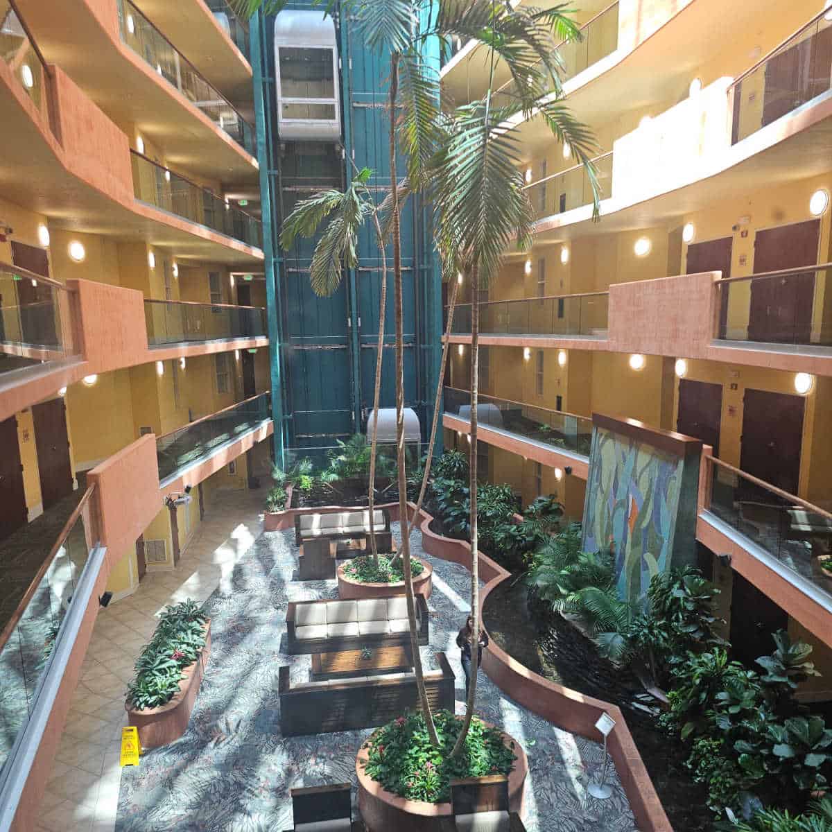 Caribe atrium with elevators in the middle, seating at the base with plants along the side