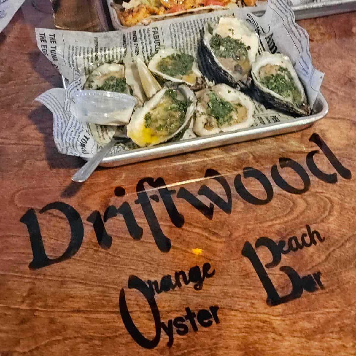 driftwood oyster bar printed on table with a tray of oysters