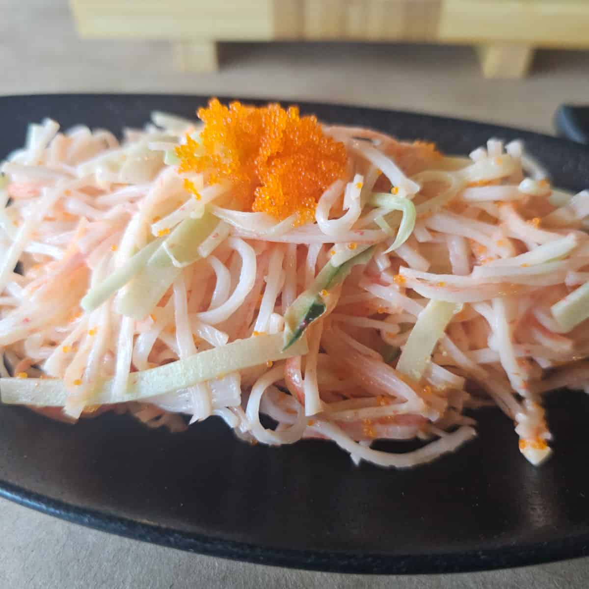 Kani salad on a dark plate