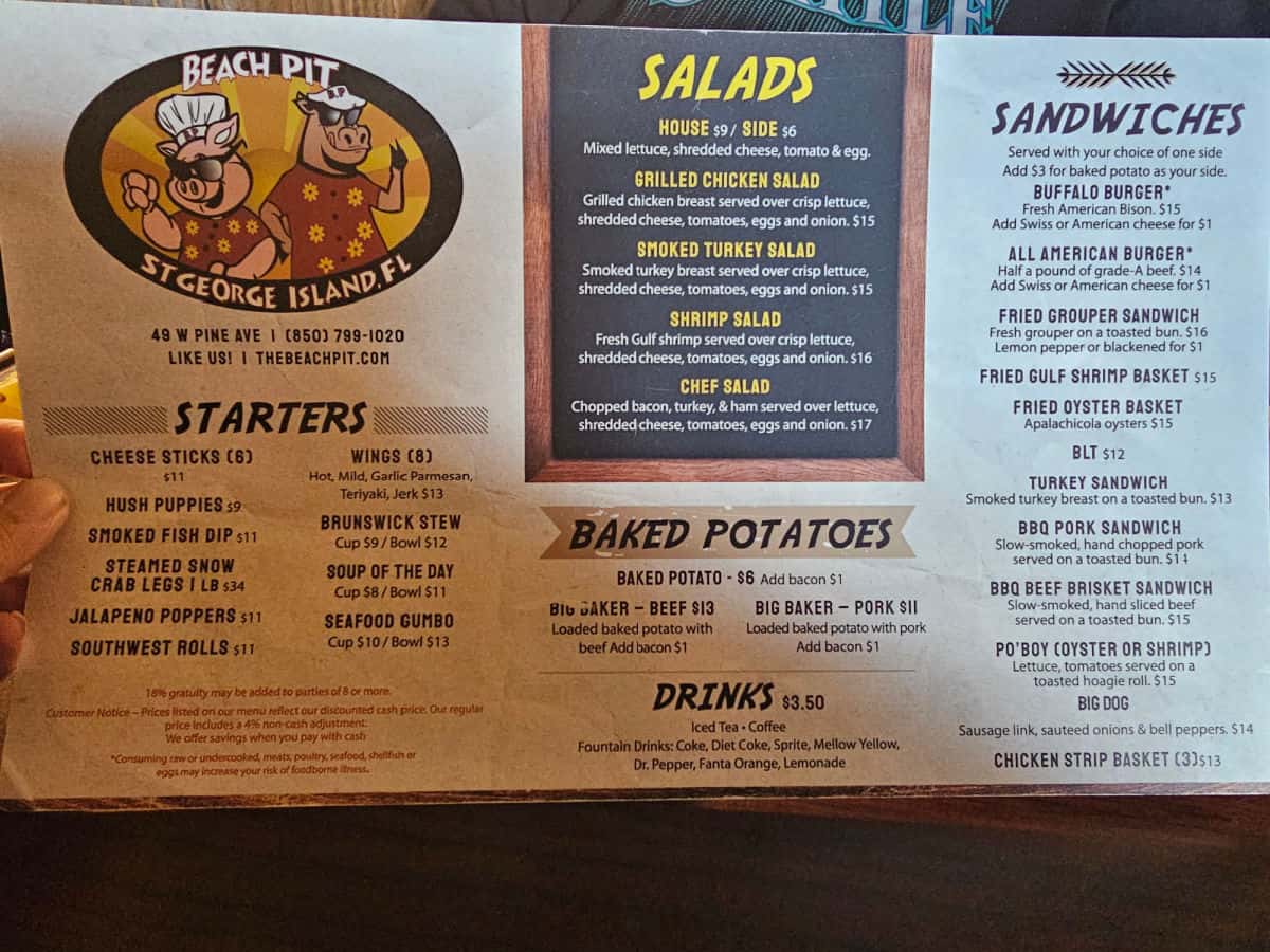 Beach pit St george Island logo on the top of the menu, starters, salads, baked potatoes, and sandwiches on the menu
