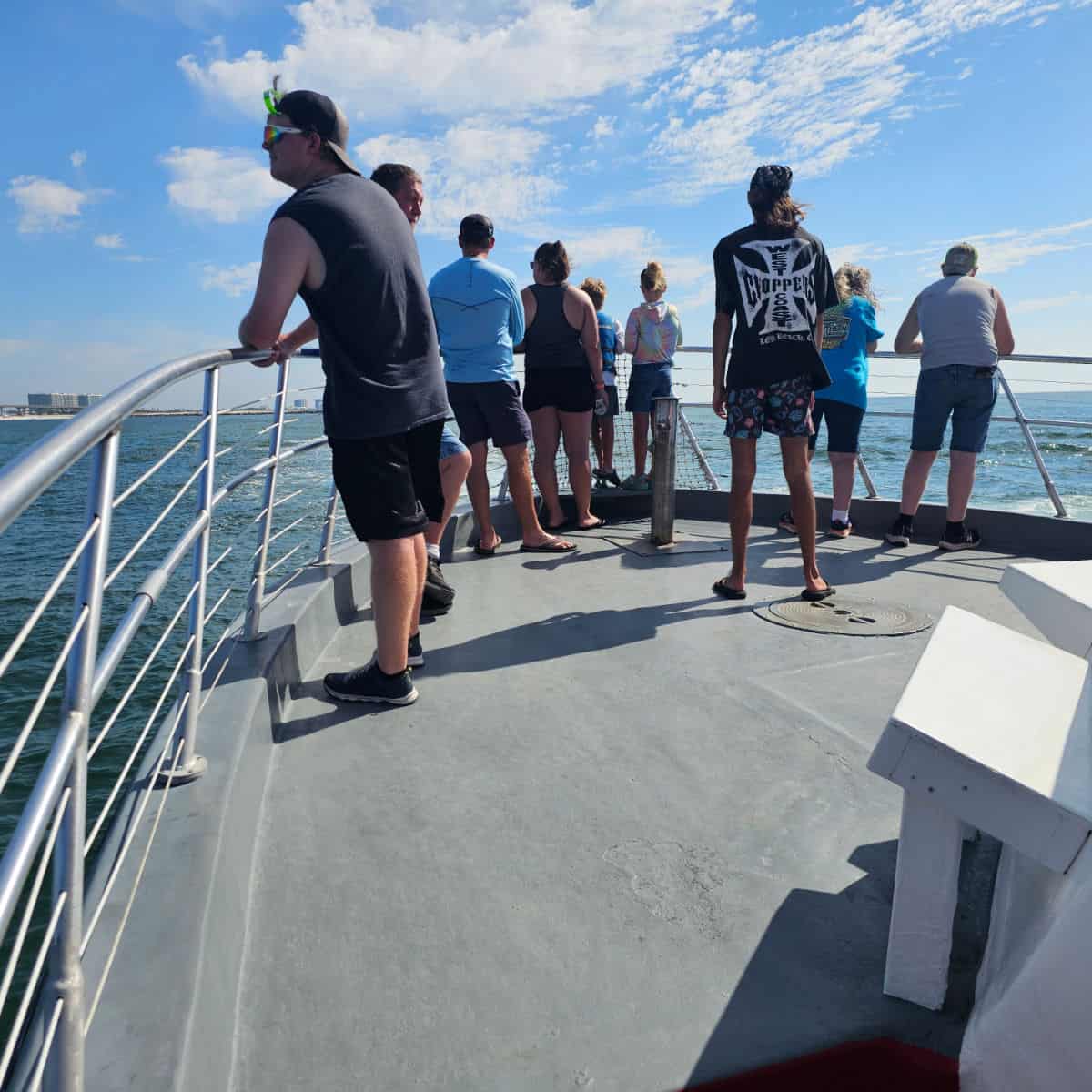 front of aboat with people standing along the rail