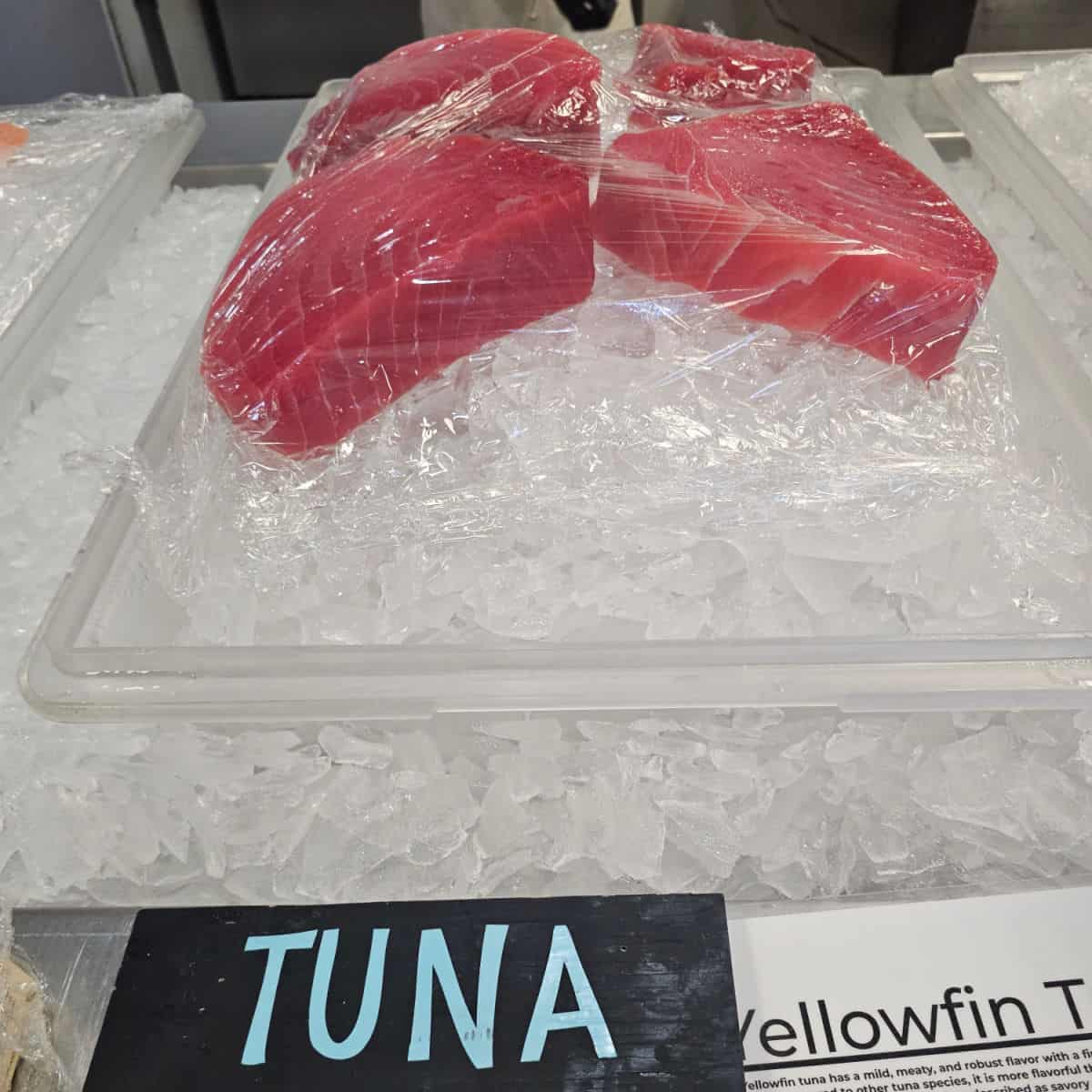 Yellow fin tuna wrapped and sitting on ice in a container