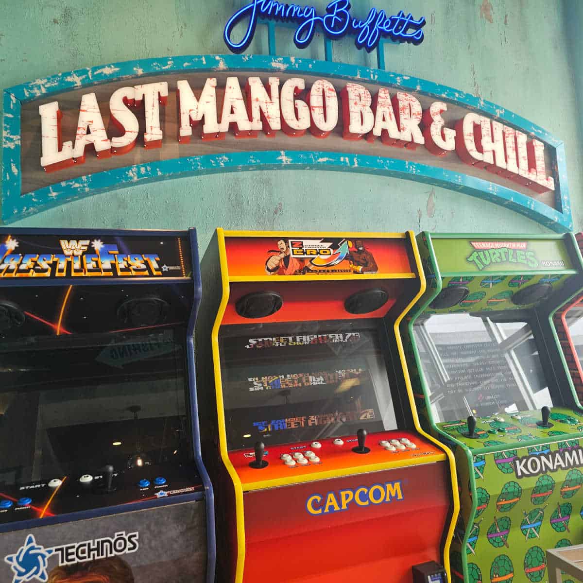 Jimmy Buffets Last Mango Bar and Chill sign over multiple arcade games