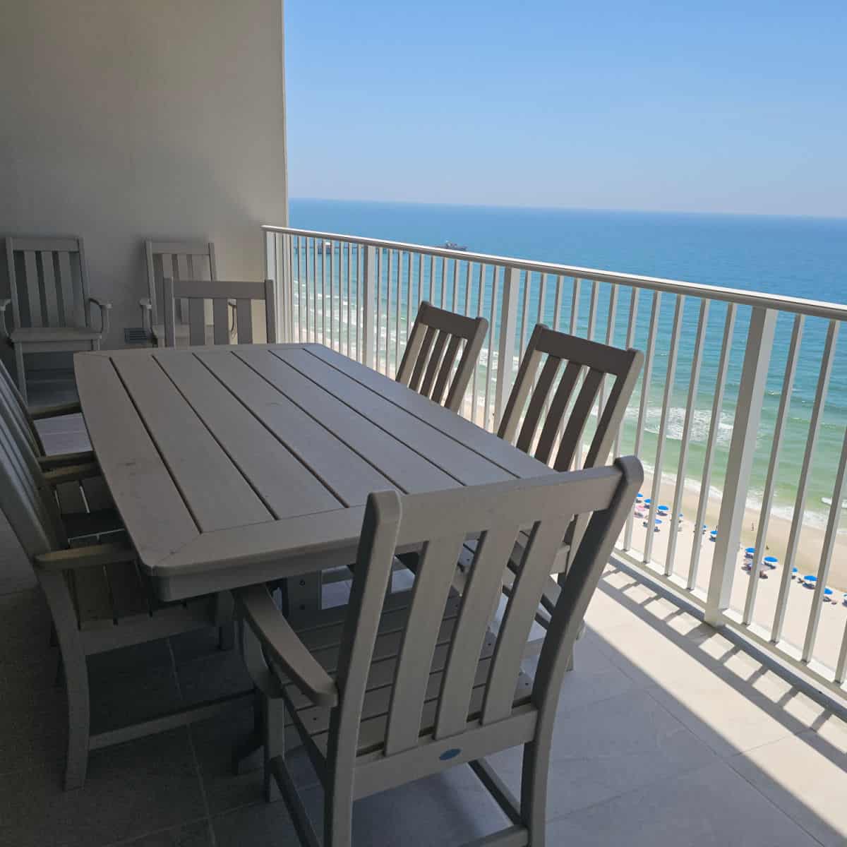 balcony with Gulf views, square table with chairs and two chairs against the wall