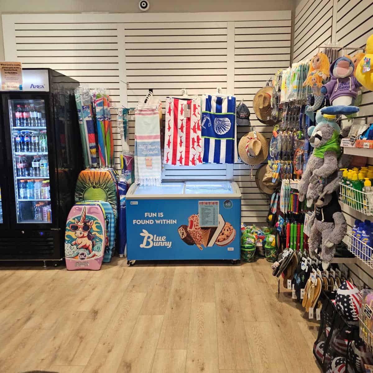 small shop with toys, ice cream, boogie boards, and a cooler with drinks