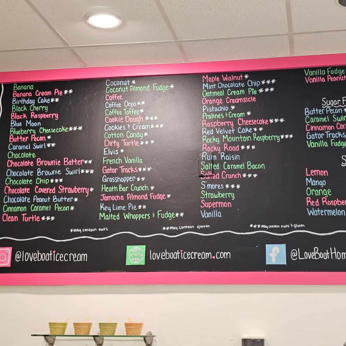 chalkboard with a list of ice cream flavors and Love Boat Ice Cream website and social info
