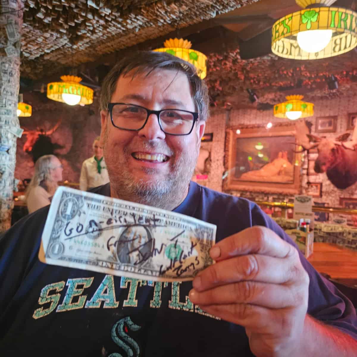 John holding a dollar bill in McGuires