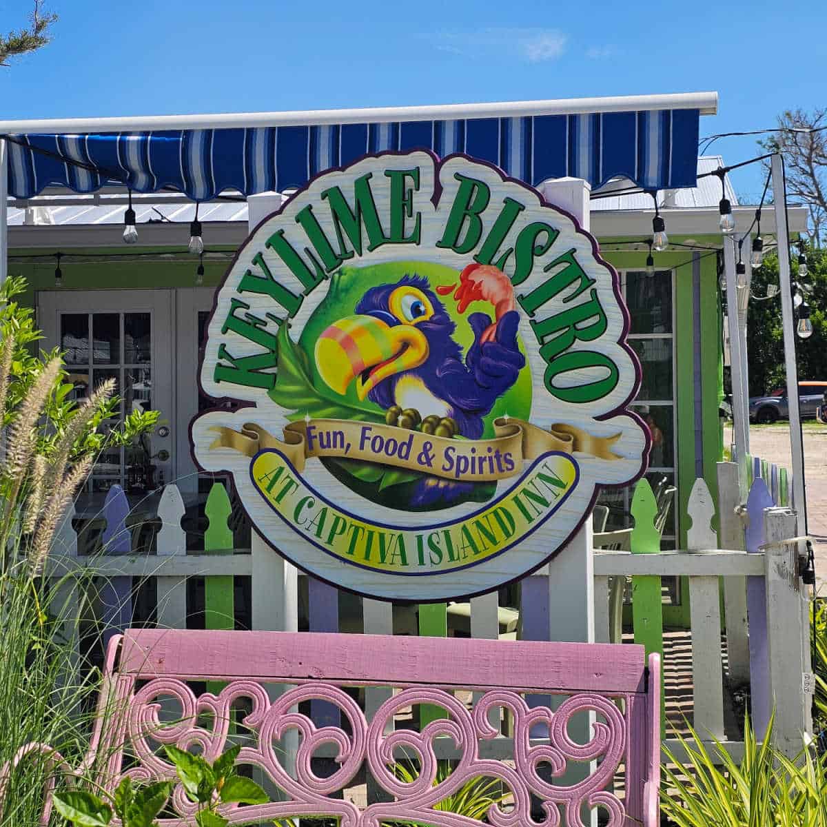 Key Lime Bistro Fun Food & Spirits sign over a purple bench