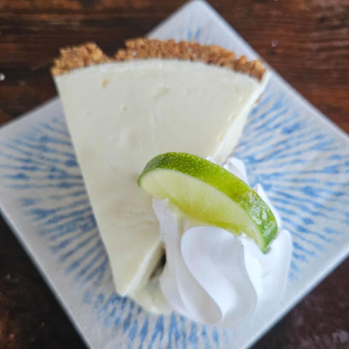 blue plate with a slice of key lime pie on it