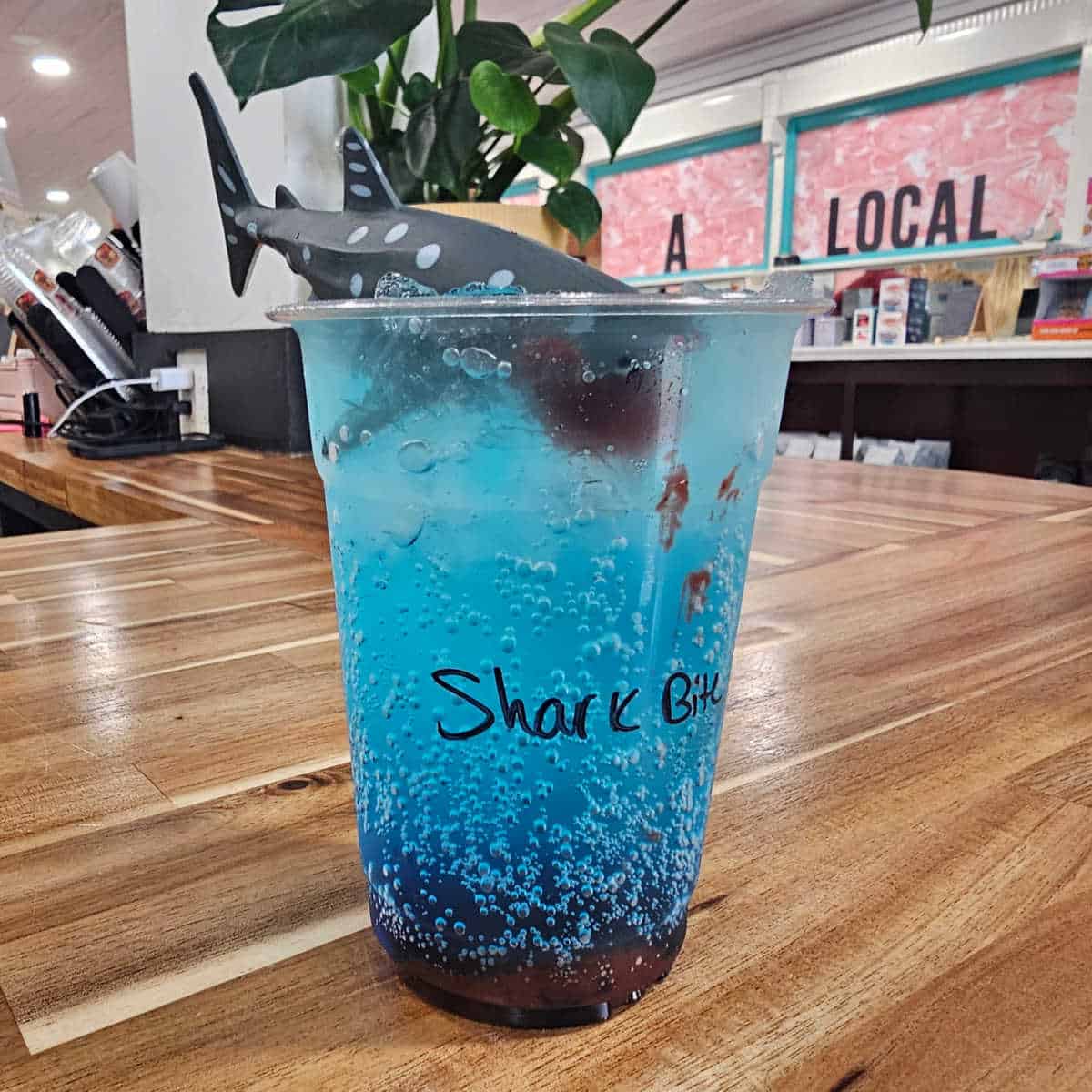 shark bite drink with a shark on the top of the drink