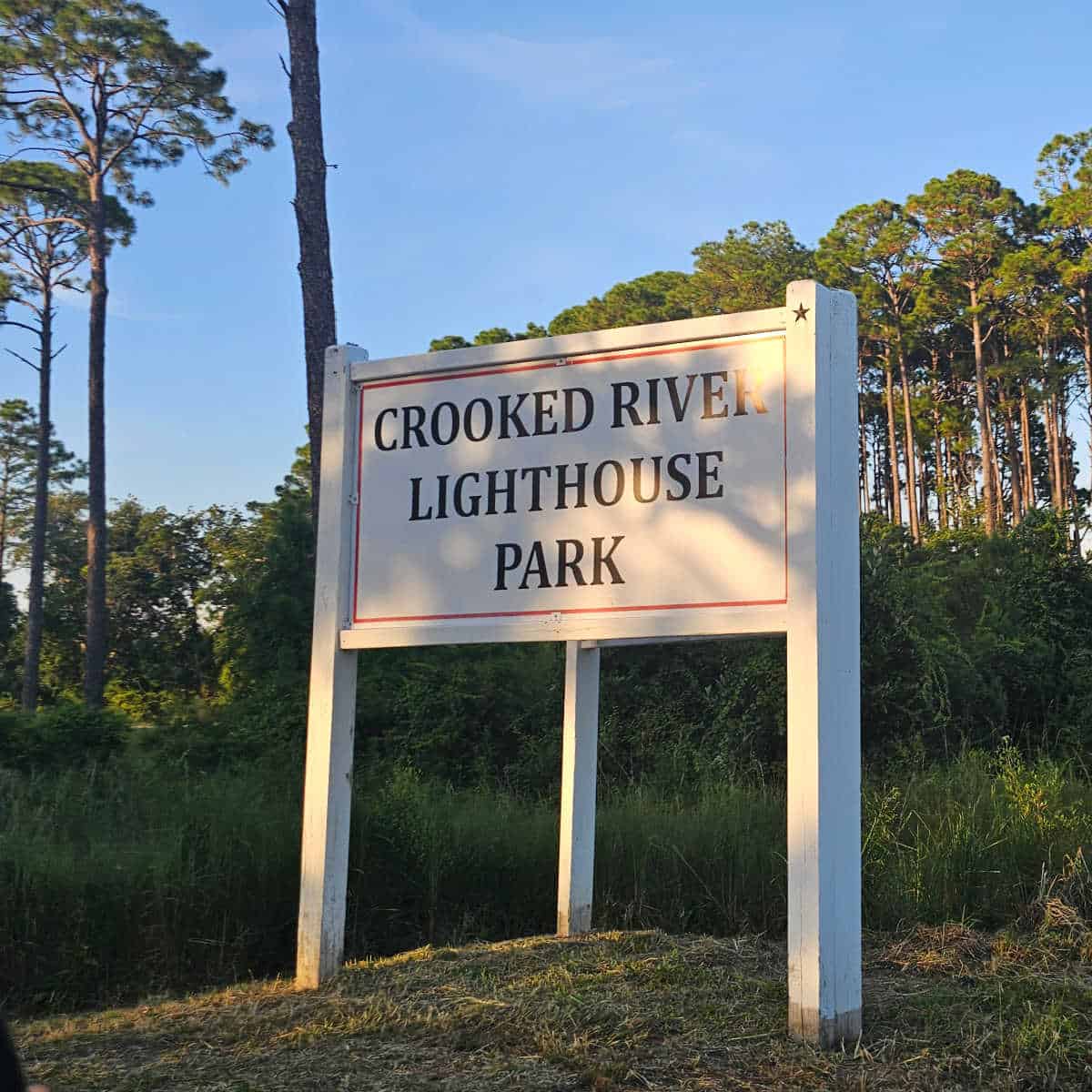 Crooked River Lighthouse Park sign with trees in the background