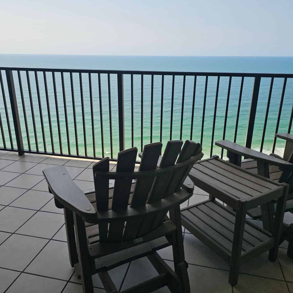 Two Adirondack chairs on the deck looknig out towards the Gulf
