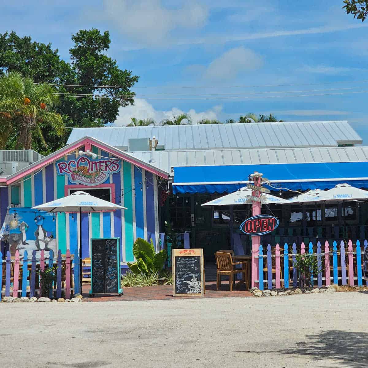 RC Otters Island Eats on the extrior of a a striped building with multi color fence