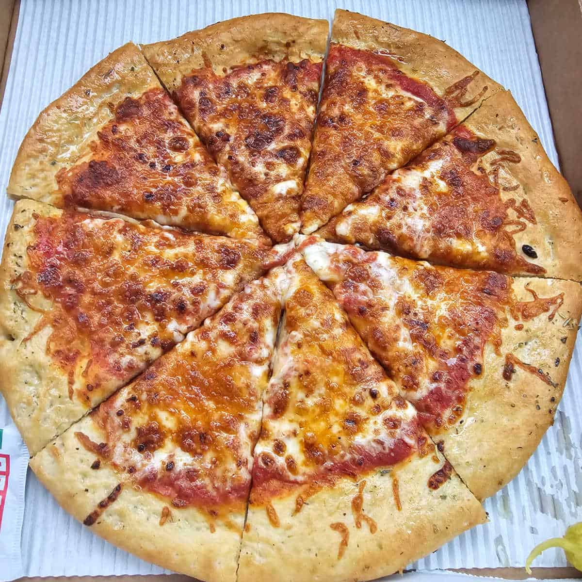 cheese pizza in a cardboard box