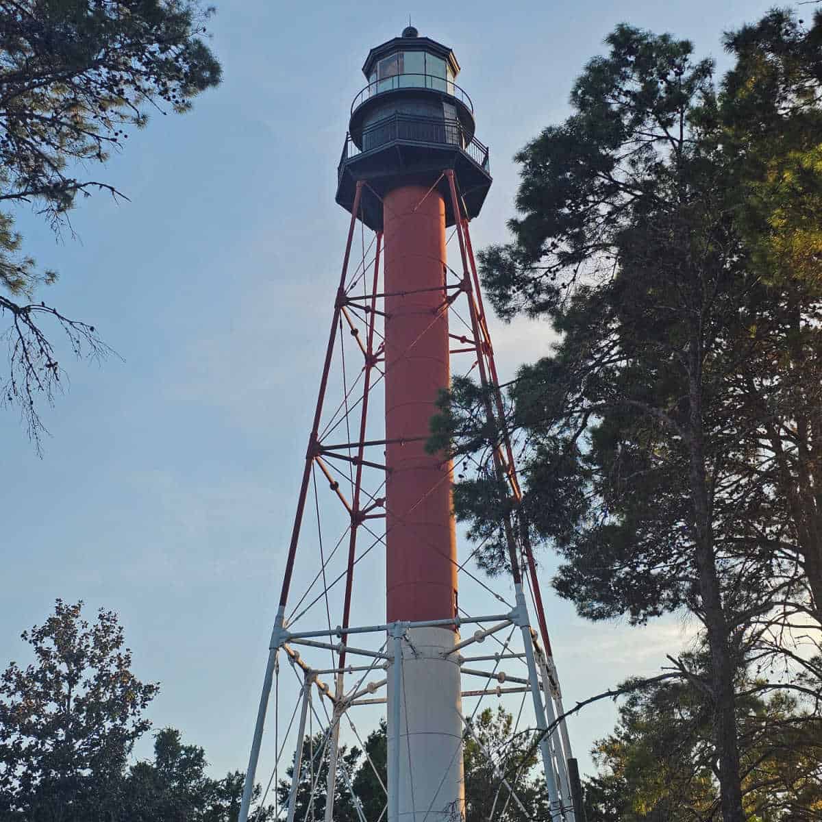 looking up at Crooked River Lighthouse with red and white center pole