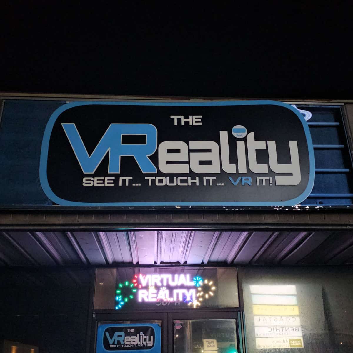 The VReality See it Touch it VR it sign over the entrance