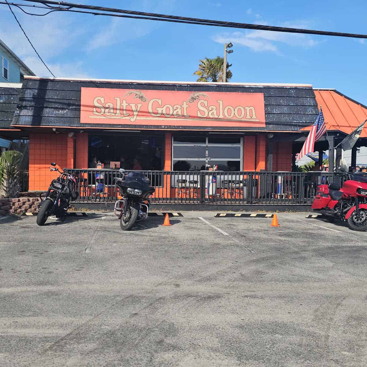 Salty Goat Saloon sign over the restaurant entrance with motorcycles parked outside