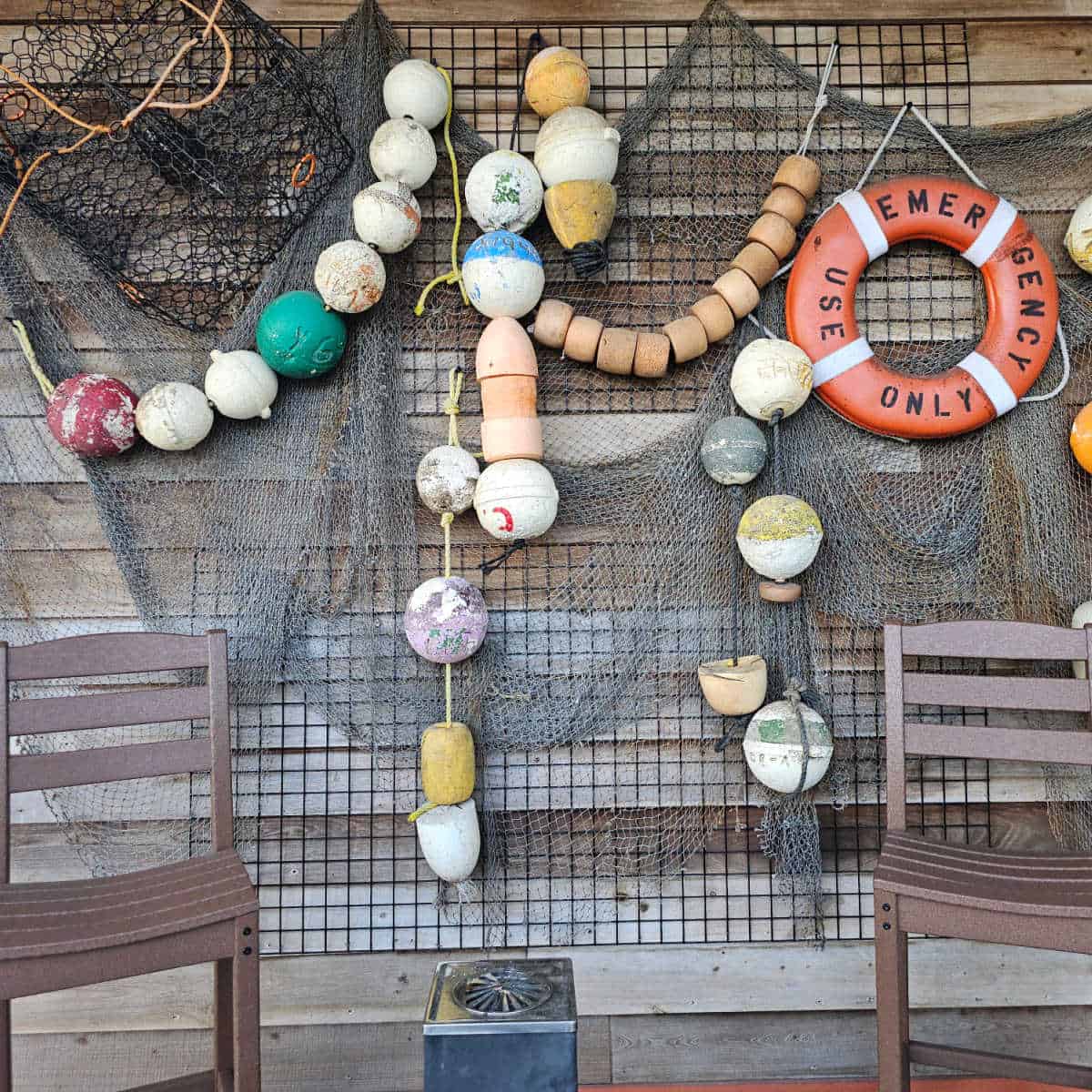 wall with fishing gear and emergency ring along with two chairs