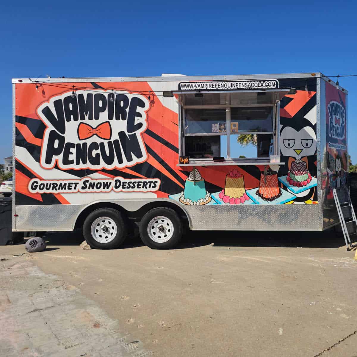 Vampire Penquin food truck with gourmet snow desserts on the side of it