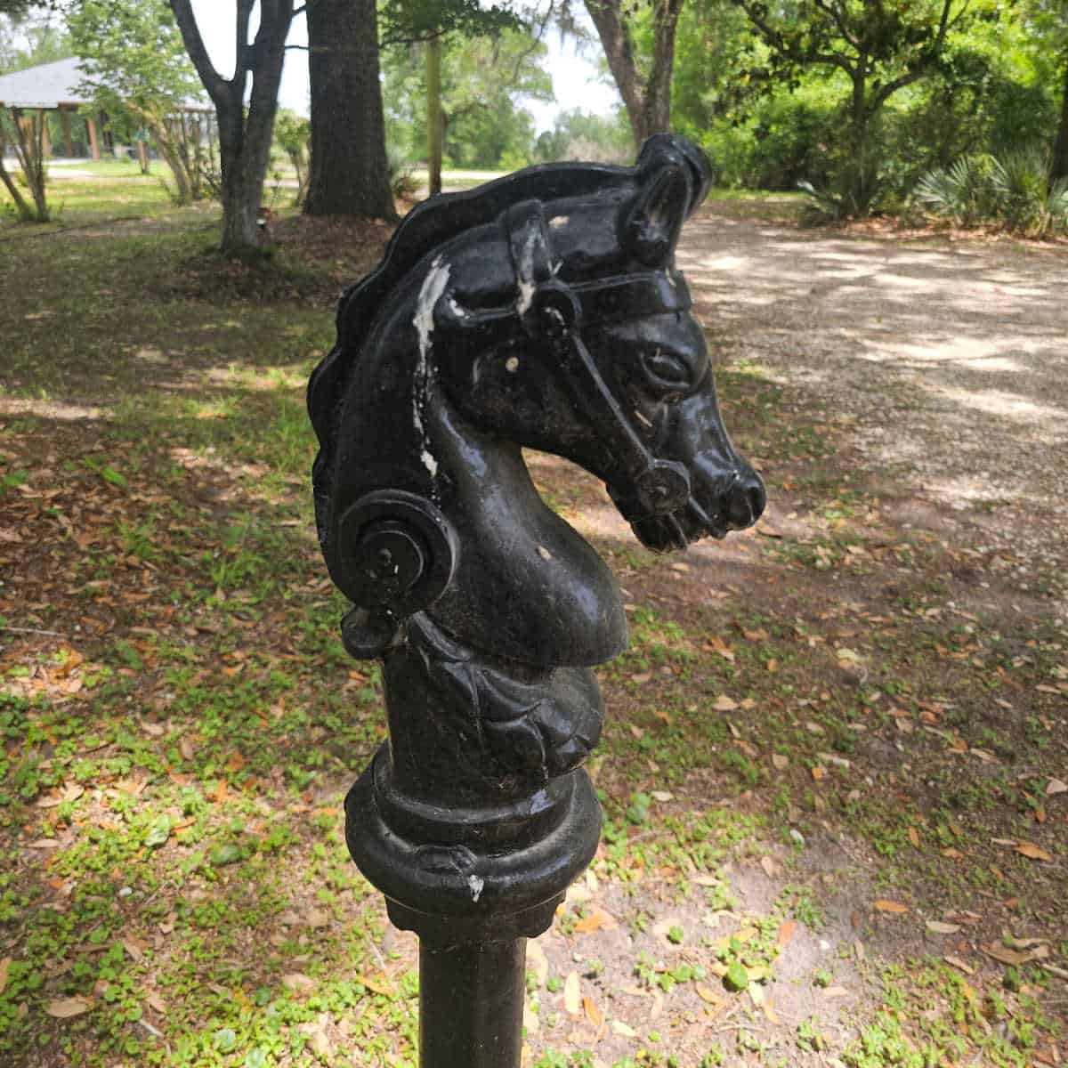 horse head pole with trees behind it