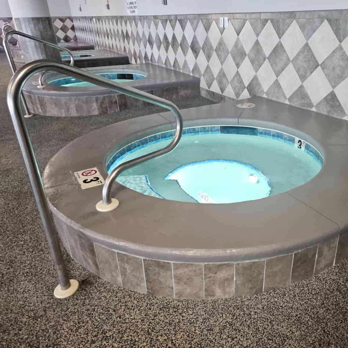 row of hot tubs against a diamond checkered wall