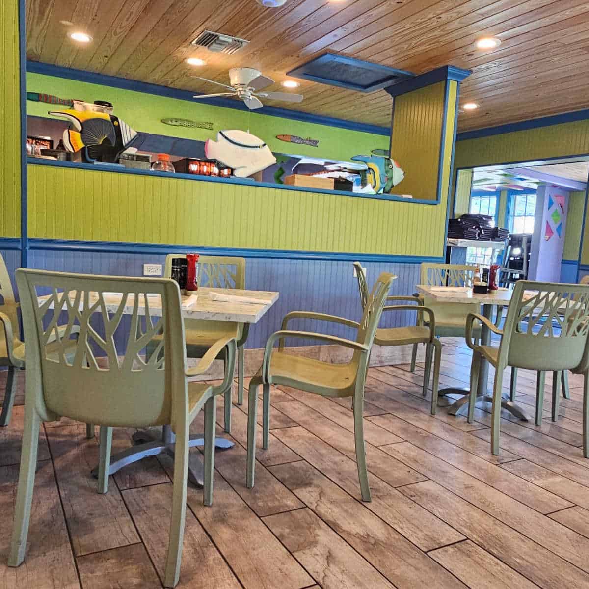 Key Lime Bistro interior with green walls and blue trim, tables with green chairs