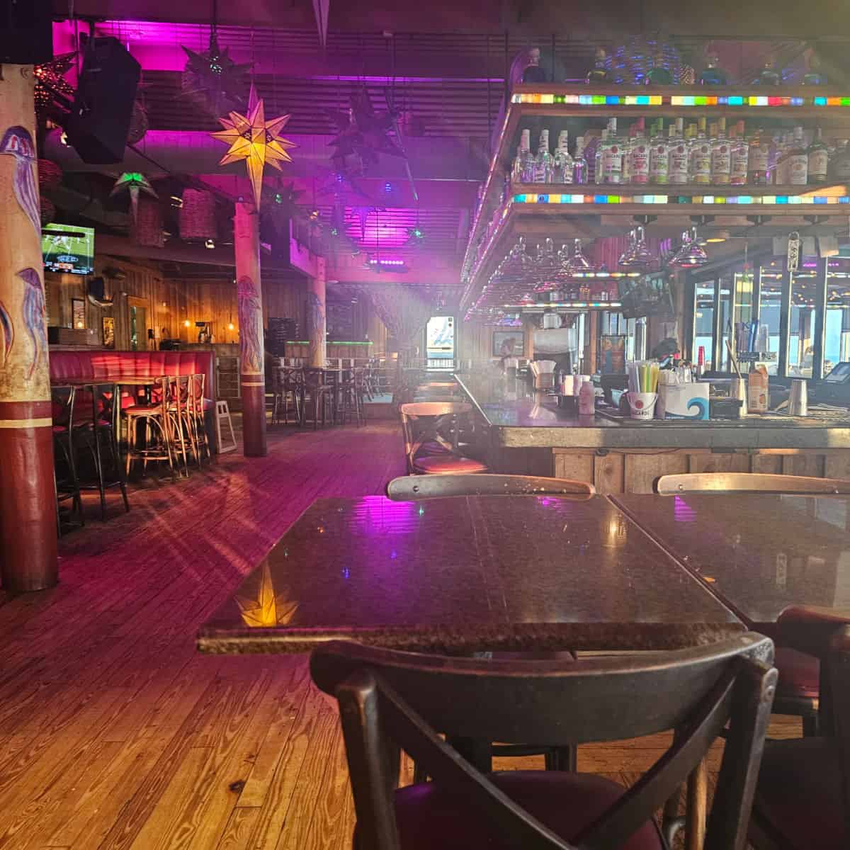 Rockin Tacos interior with bar area and tables and chairs under colorful lights