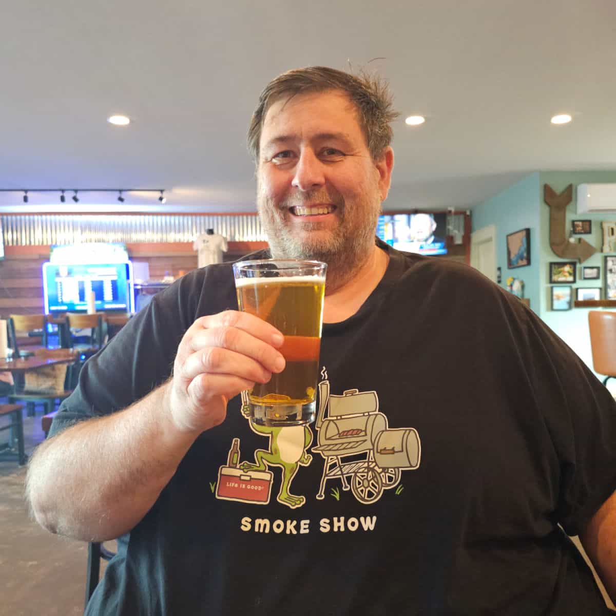 John holding a beer in Forgotten Coast Brewing Co